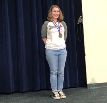 Junior Natalie Brink receives bronze metal in news-writing at the UIL state competition.