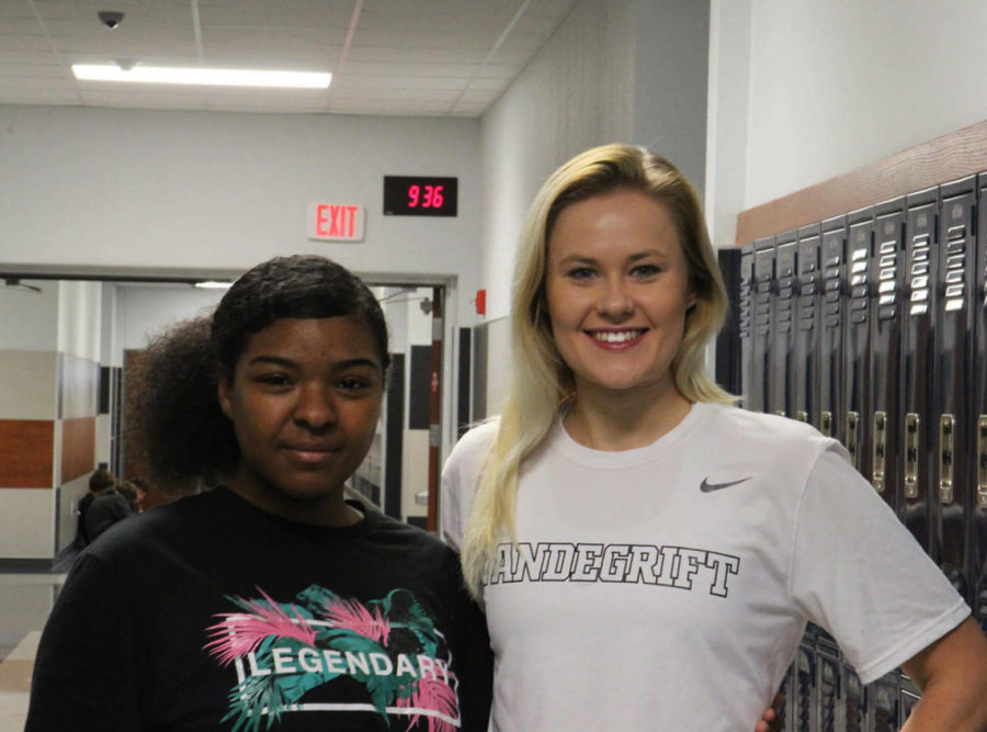 Thomas and Litton pose for the camera outside her classroom