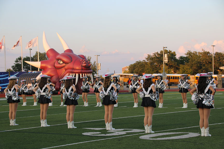 Before the team runs out of the inflatable viper, Legacies welcome them along the sidelines. It is super fun to be lined up waiting for the football players to come out because we are all super excited for the game and the stadium atmosphere is always super exciting, senior Laura Parish said.