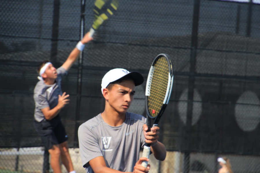 Varsity tennis players, Zach Fowler and Zach Quattro, practicing for bi-districts. 