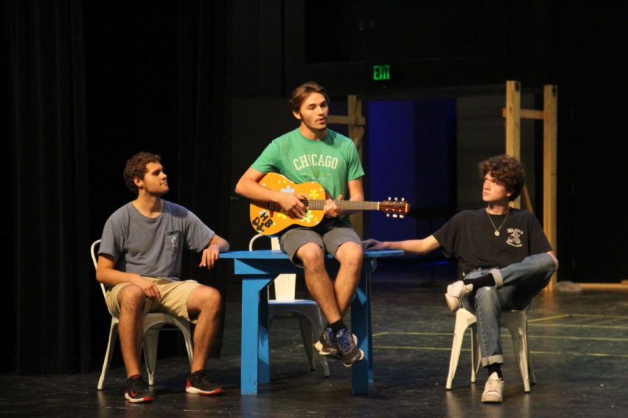 Seniors Sam Smoot, Zander Harrison and Mick Smith (left to right) perform Thank You for the Music during the rehearsal run through of Act 1. 