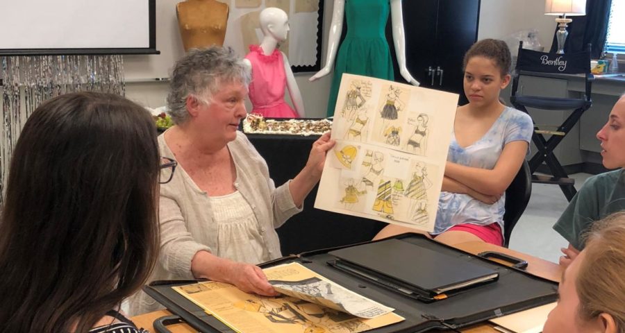 Carol Fergus shows off old sketches to students.