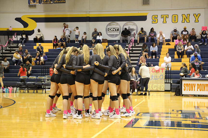 Meeting for their pregame huddle after warming up. Whenever I play Im always motivated to play my best, I play for my parents because without them I wouldnt be at my level of play today, sophomore Chloe Charles said. 