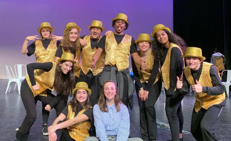 Joes Cafe performers pose after the show in their costumes.