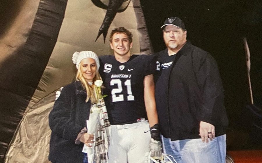 Jax Mccauley (middle) poses with his parents during senior night.  