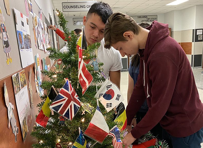 Martyn Elorz and Franciszek Jablonski finalize the diversitree decorations at the front of the school.