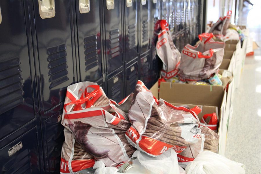 Key club organizes donation boxes outside library for annual food drive.