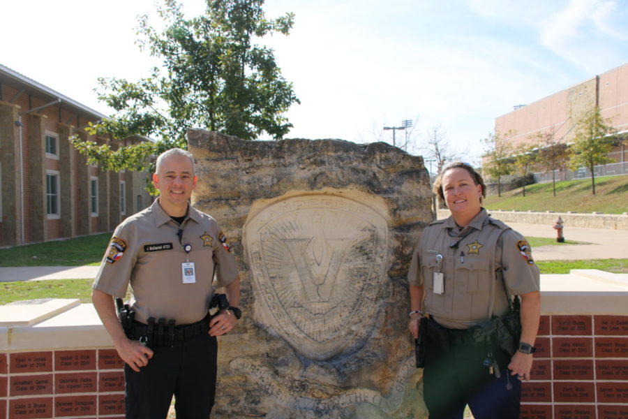 Officers McDaniel and Richards stand next to the Vandegrift plaque.