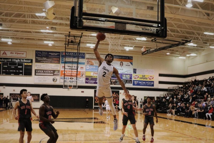 Greg Brown going for a dunk during playoff game against Langham Creek.