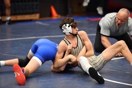 Carter Taylor takes down opponent during recent wrestling match this year.