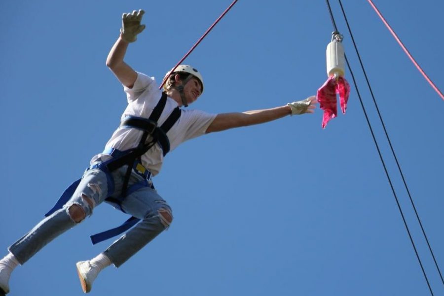 Senior Micheal Parrington takes a leap of faith on the high ropes to catch the bandana