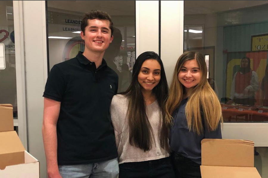 Bamboo Box team stands behind business information booth at family health night