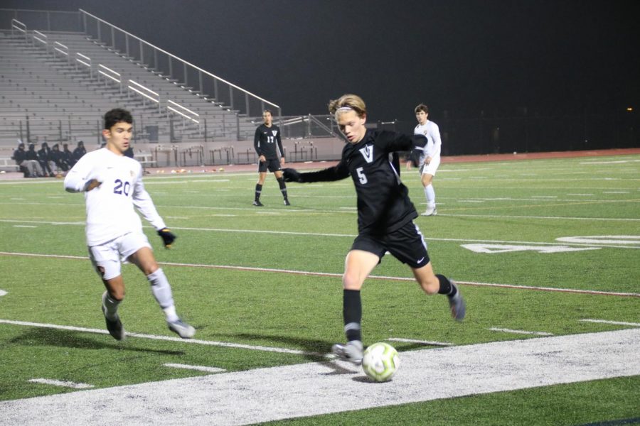 Junior Cade Dougan guarding the ball in a game against Stony Point High School.