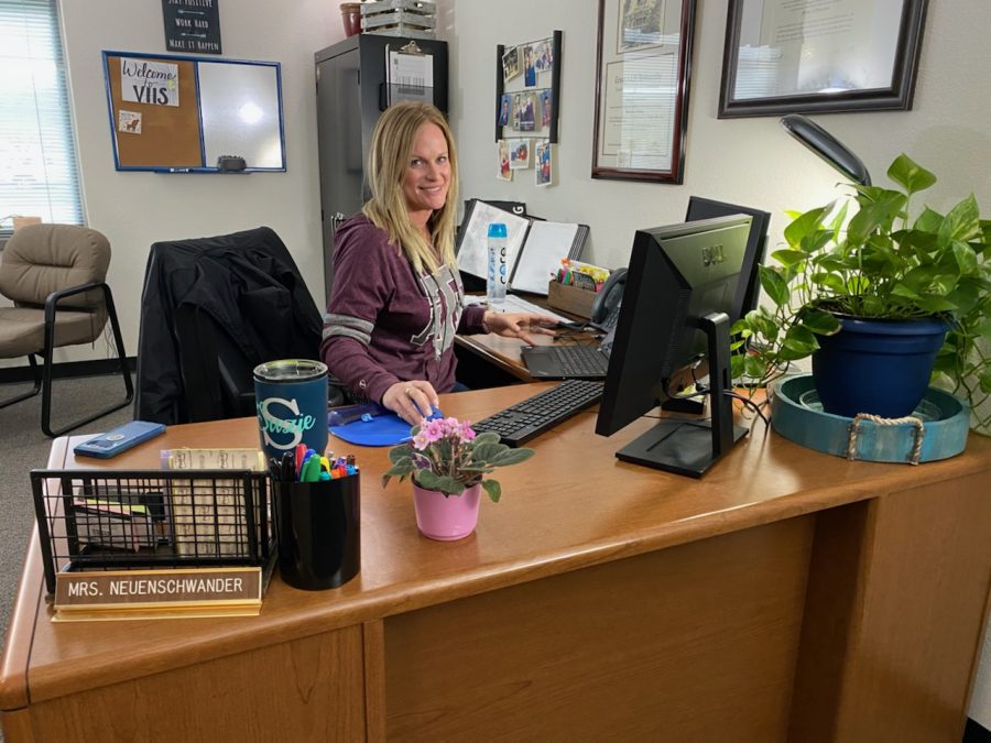 Ms. Neuenschwander in her office, getting ready for students to arrive.