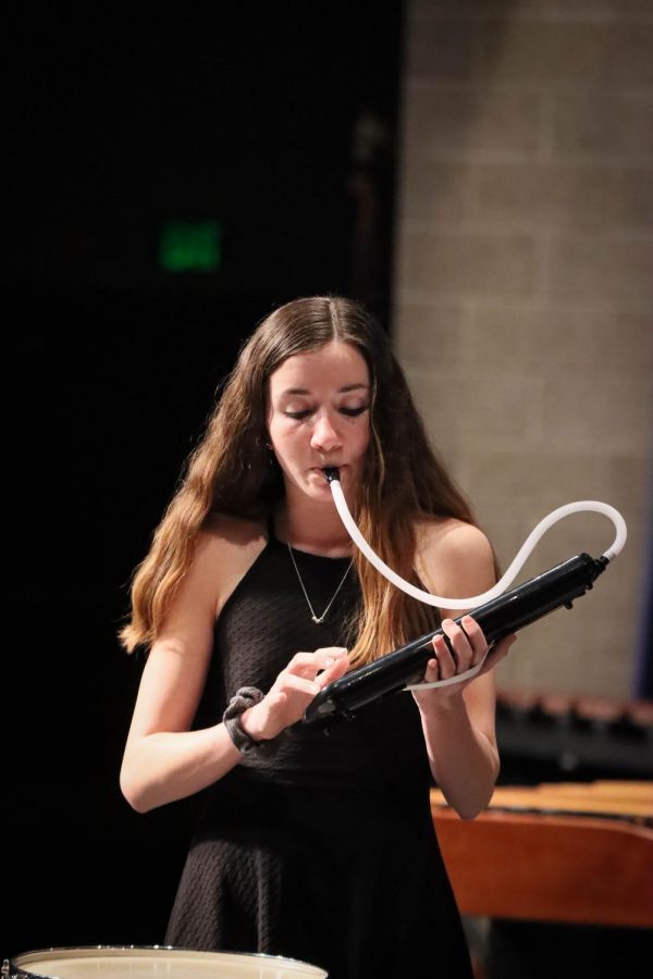 Junior Kylie Bryan plays the melodica, a handheld piano, in a Wind Ensemble piece. It was such a cool experience because it combined percussion technical skills with the aspects of wind techniques, Bryan said. 