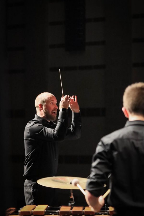 Director of percussion Joe Hobbs conducts the Wind Ensemble in their final piece of the night. The piece, "Fireflies," was a extremely difficult composition that left the crowd in awe. 