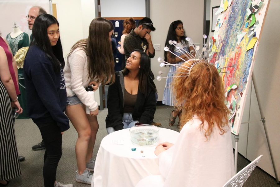 IB students interact with the audience during their art exhibition. 
