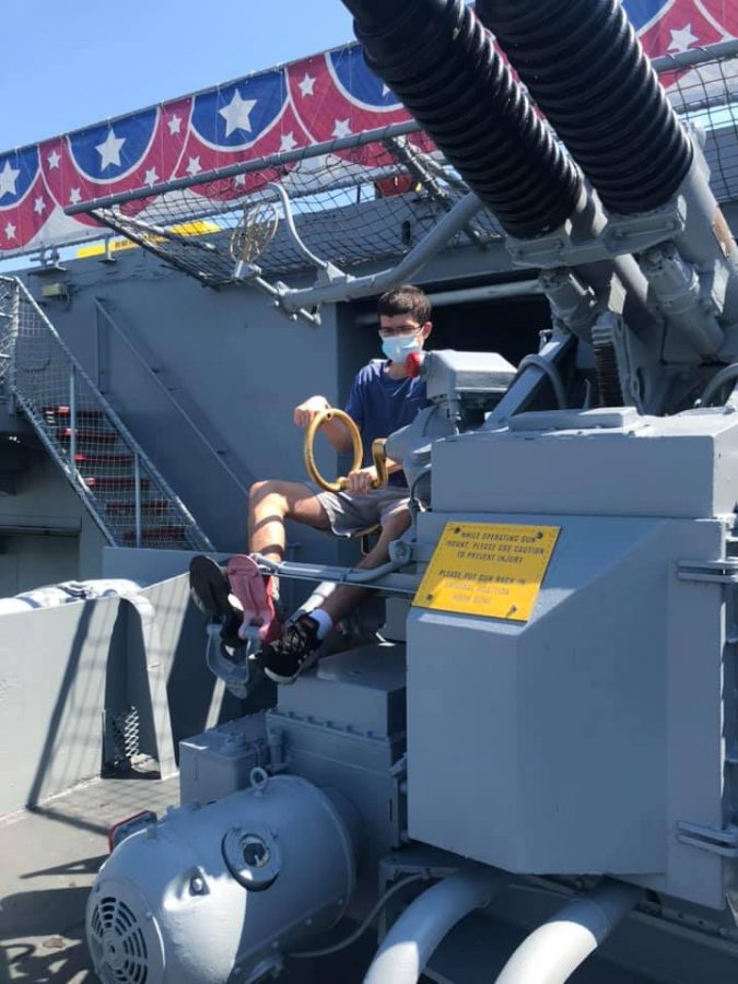 The author, Nicholas Scoggins, playing with one of the USS Lexingtons 5 inch guns.