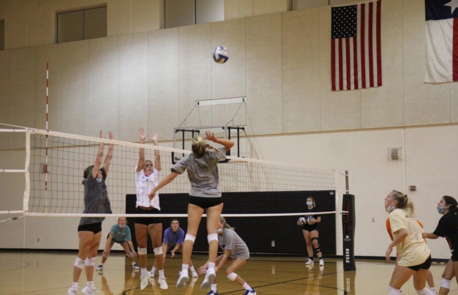 The VHS Volleyball team practices while wearing masks to stay safe during the pandemic.