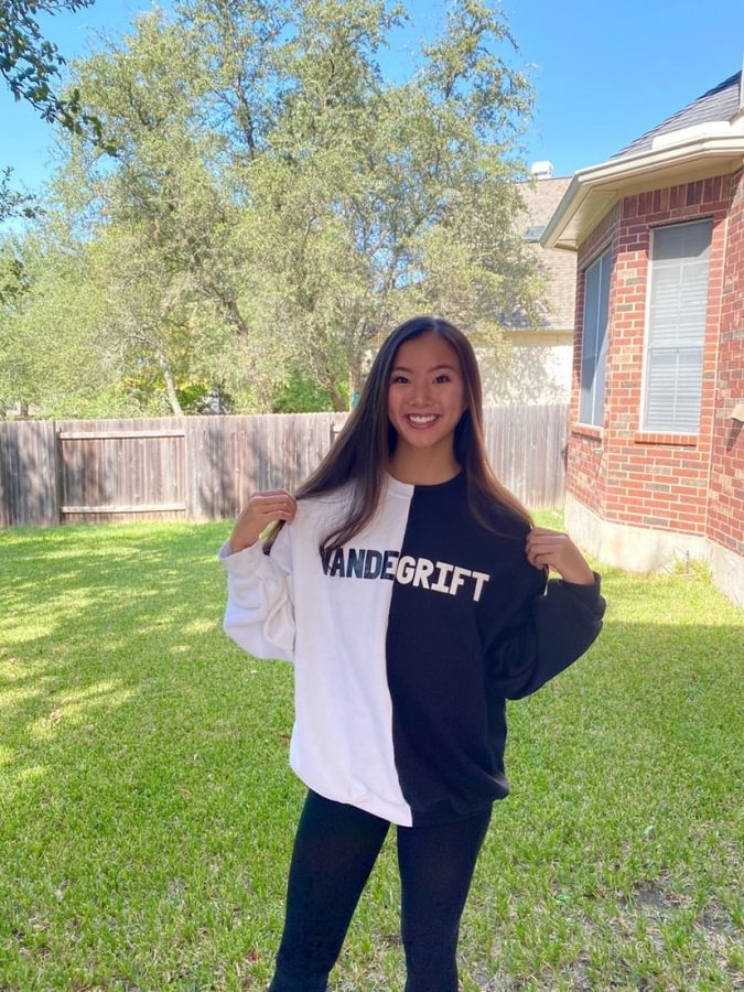 Natalie Wong smiles, as she models her new Vandegrift sweatshirt 