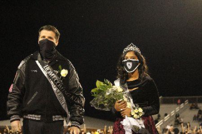 Valluru and Hartman stand in shock amidst cheers as their homecoming court win is announced.