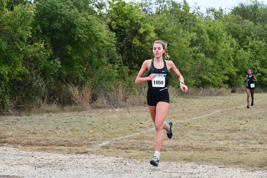 Senior Gemma Goddard runs through the Old Settlers Park course in Round Rock  at the district meet Oct. 27. 