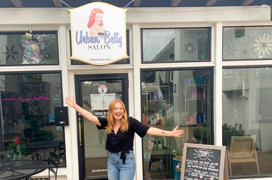 Vandegrift alumna and hairstylist Julie Latimer poses in front of Urban Betty.