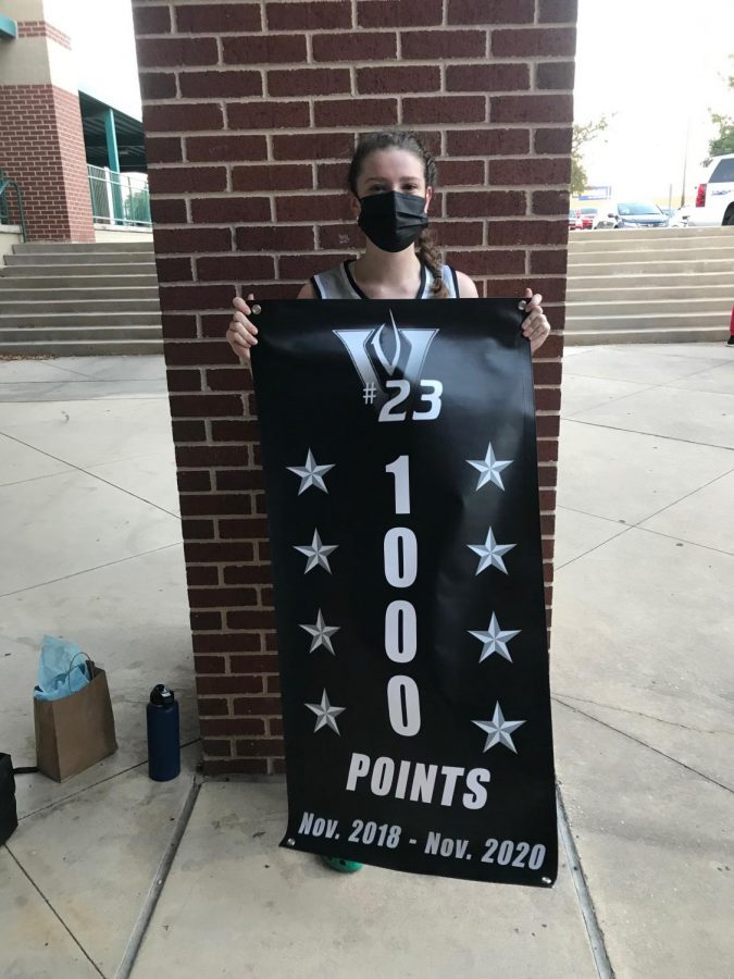 ORourke shows off banner to celebrate her accomplishment of scoring 1,000 points during her time on the team.