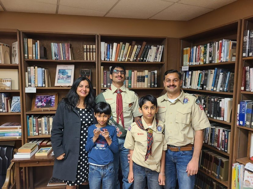 Jalwal poses for a picture with has parents and siblings after becoming an Eagle Scout.