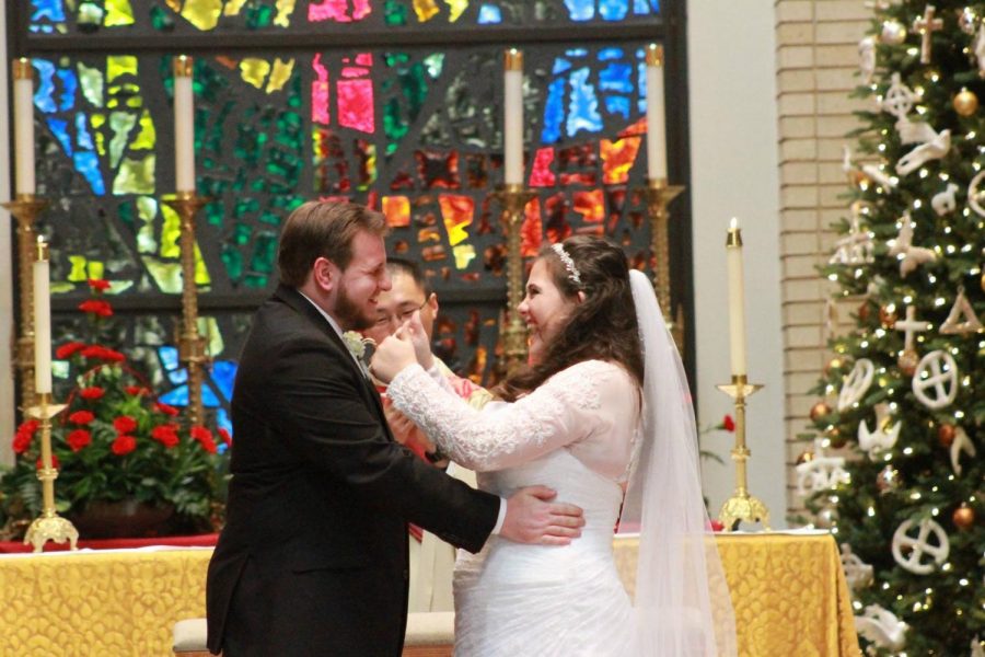 Maria Talbot gives Brian Talbot a thumbs up on their wedding altar.