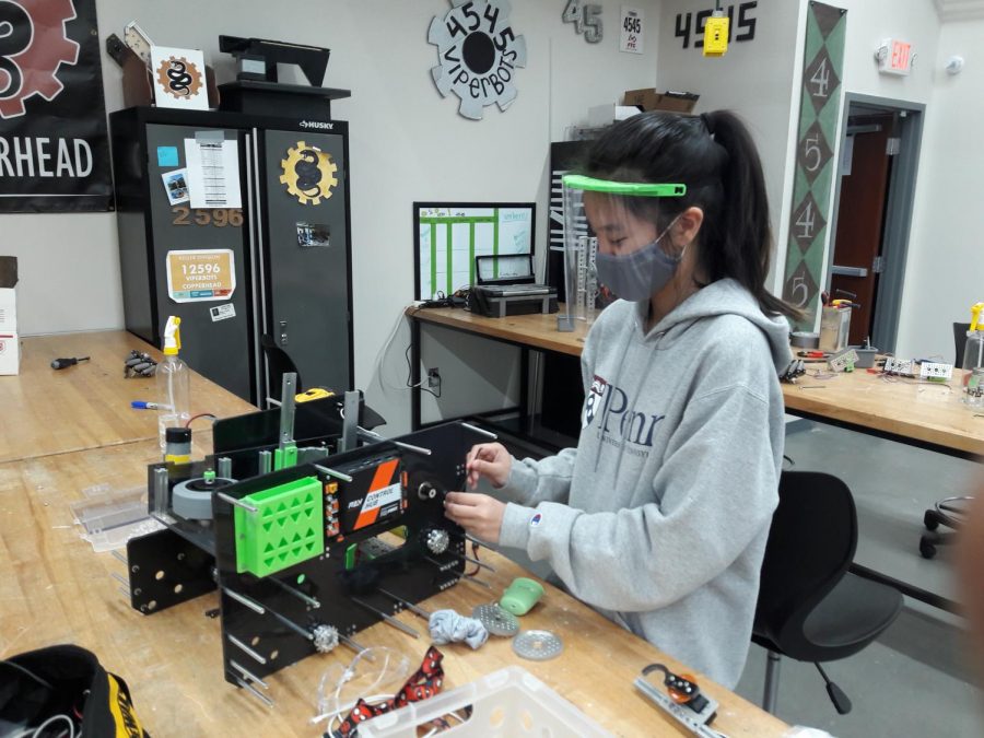Caitlyn Hsieh works on building the robot for the FTC 4545 ViperBots team.