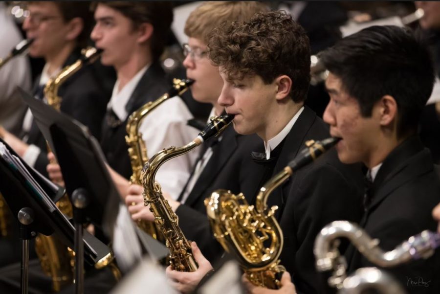 Eric Parmelee and other band students pictured playing their instruments.