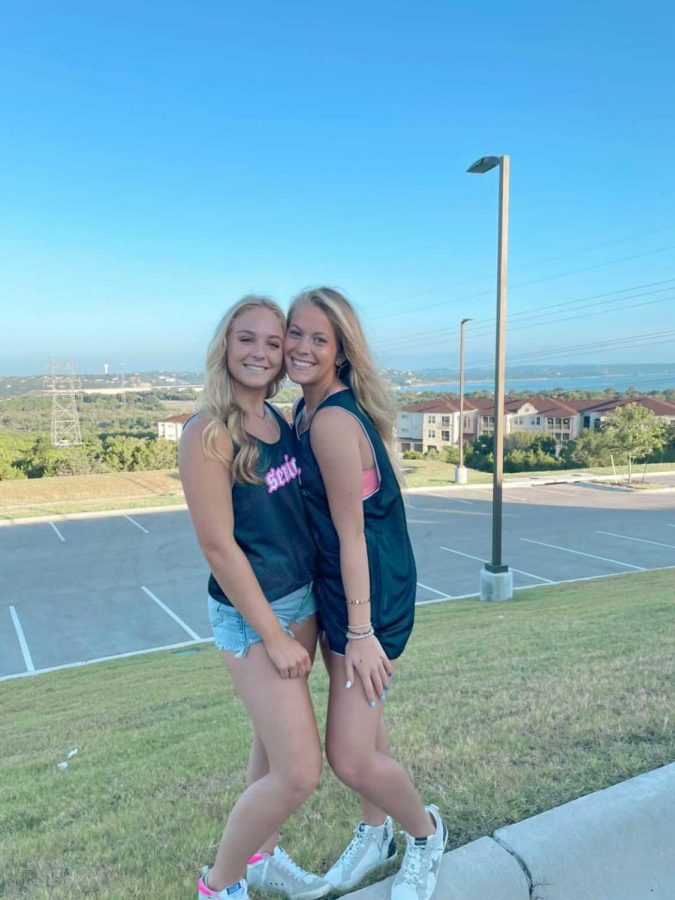 Taylor and her friend pose in their senior jerseys on the first day of school