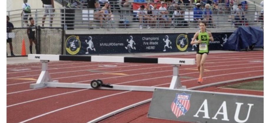 Garrett gets ready to jump over the hurdle in one of her laps at the National Junior Olympics