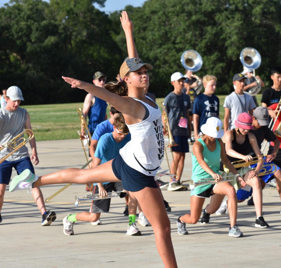 Vision dancer Ava James performs choreography during summer band practice.