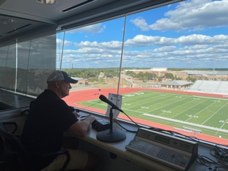 Brad Stanton sits in the sound booth, practicing and preparing for when he announces at the varsity football games