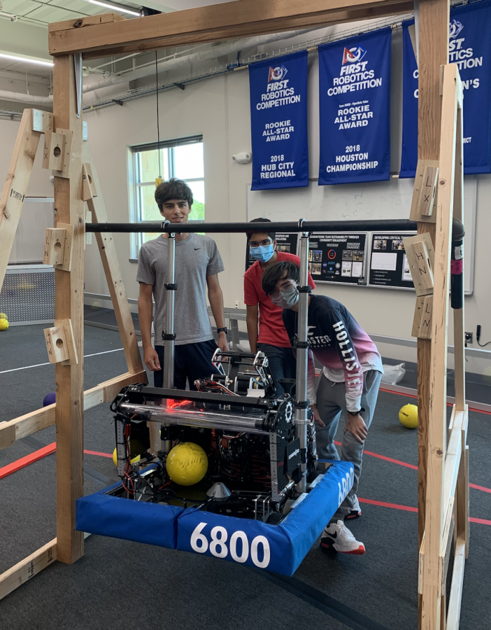 Andrew Cloran[left], Shaunak Pandey[middle], and Andrew Escott[right] pose next to their robot