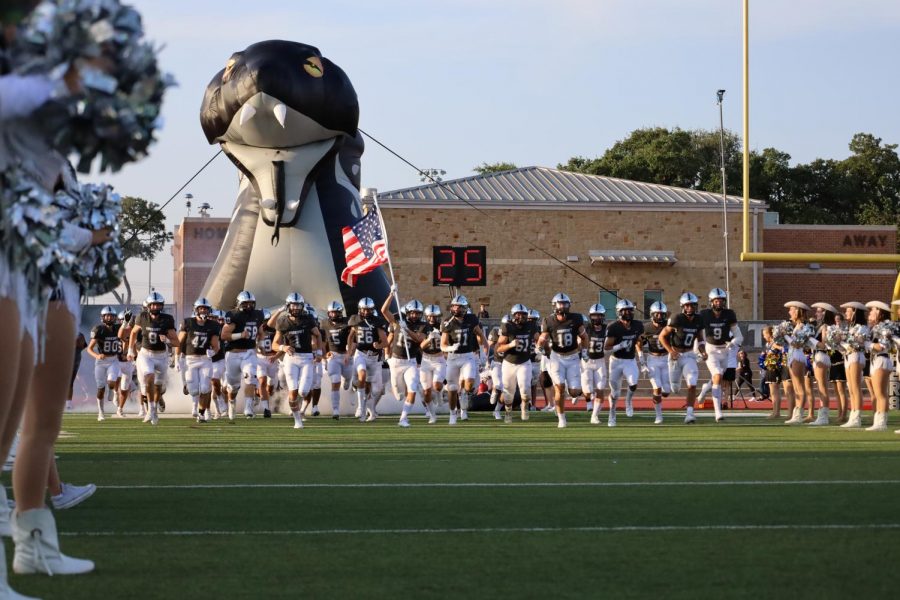 The varsity football team runs out of the Viper tunnel before the Friday night game against Killeen. There was no mascot present besides the snake tunnel. 