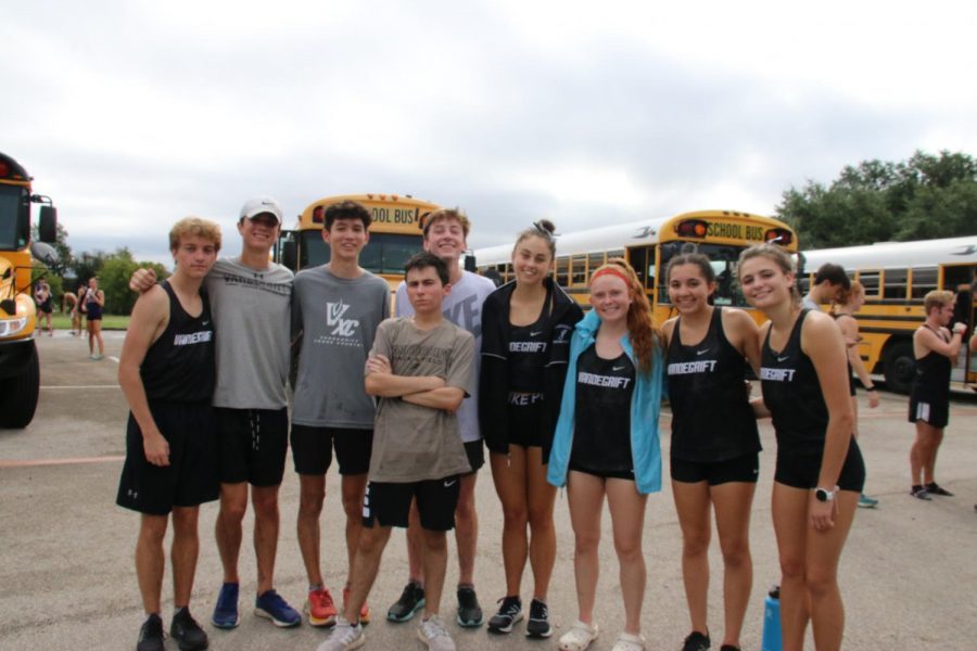 The JV boys, JV girls, and Varsity racers pose for a photo before they go off to compete