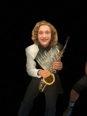 Lucas Eppele all dressed up in his band uniform and holding his instrument