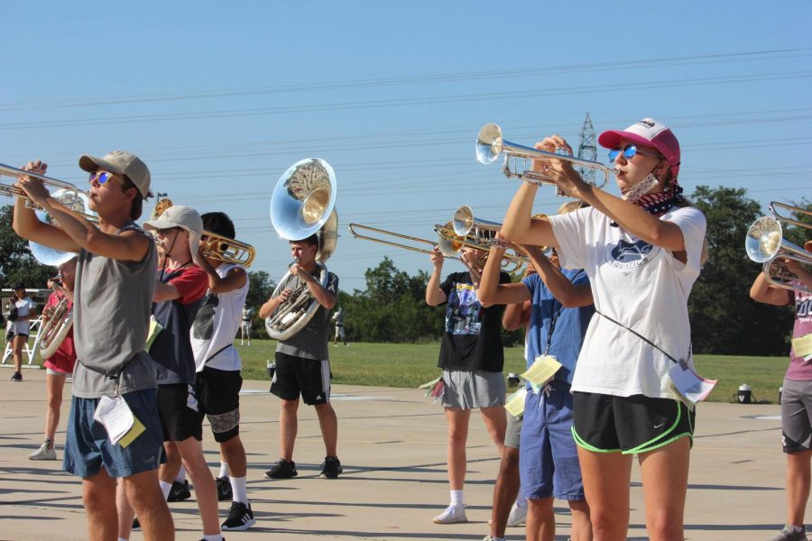 Members of the high school band practice amidst the lifting of COVID restrictions.