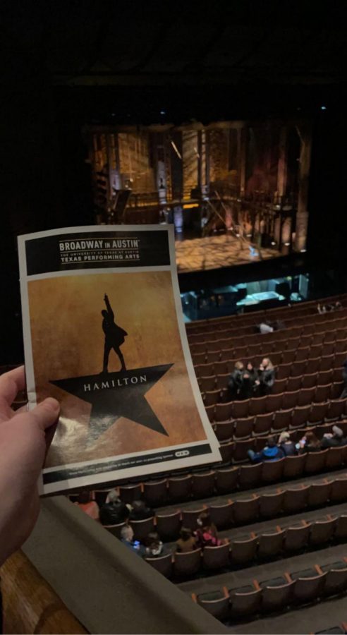 Holding the Play Bill in front of the stage at the Bass Concert Hall.