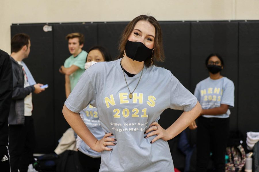 Senior Kate Denning poses for a photo showing off her NEHS shirt