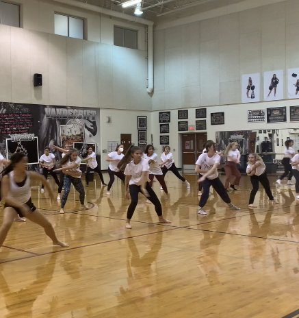 The juniors and seniors run their modern piece during an afterschool practice