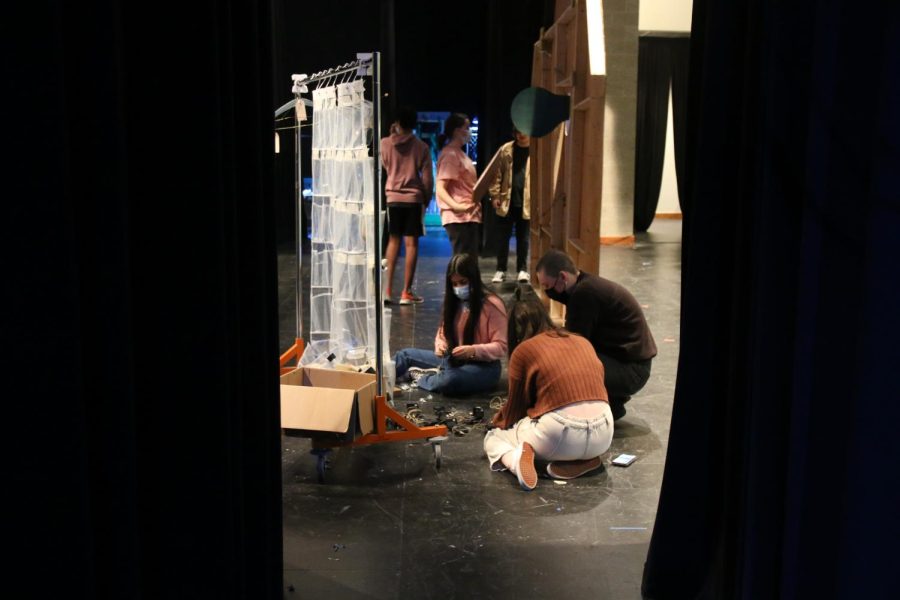 Some of the crew members gather things up before rehearsal begins.