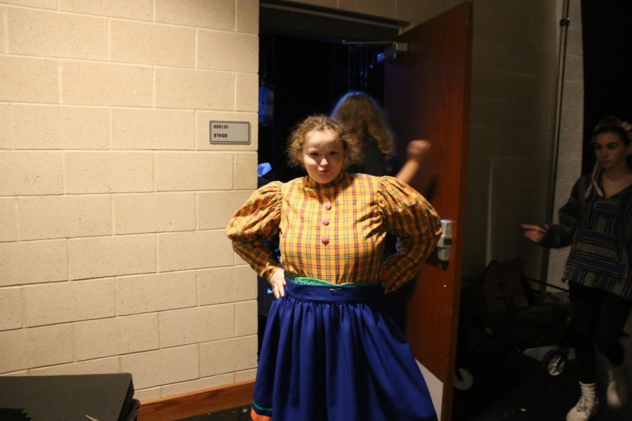 senior Harper Collier, poses in her munchkin costumer. Something Im hoping the audience is looking forward to the flying effects because weve been working really hard on it,  Collier said. 