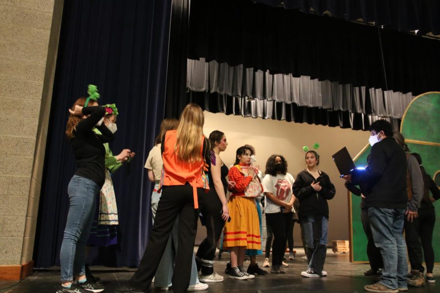 Some of the cast members gather around before the rehearsal begins