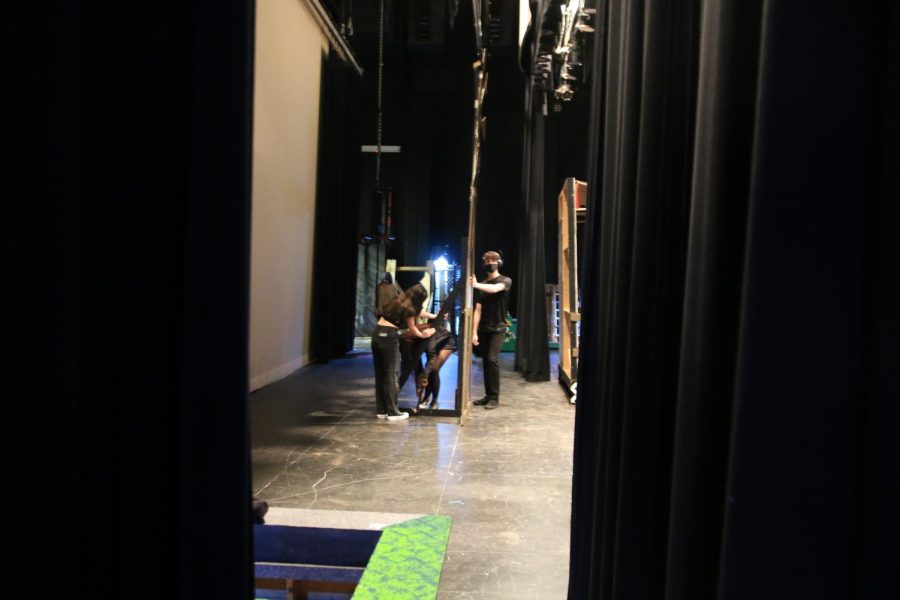 junior Dayna Ung and two other deck crew members, Alisa Assed and Christopher Miller help get the stage all set for rehearsal