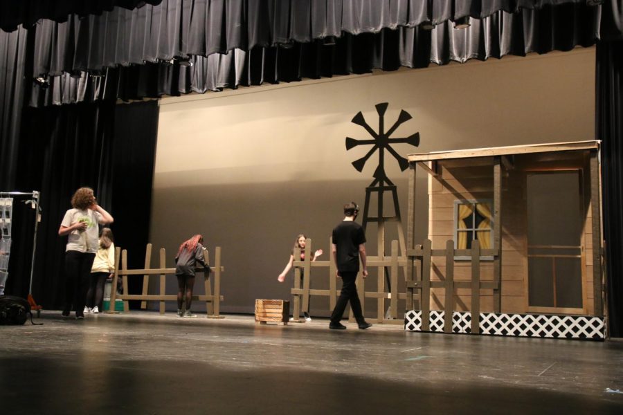 Deck crew help set up the first scene of the play.