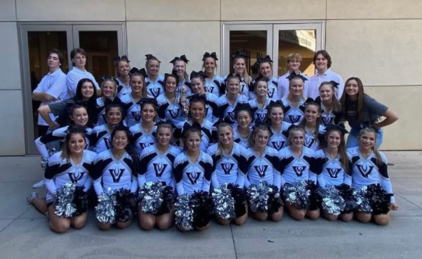 The cheer team posing for a photo outside of the convention center